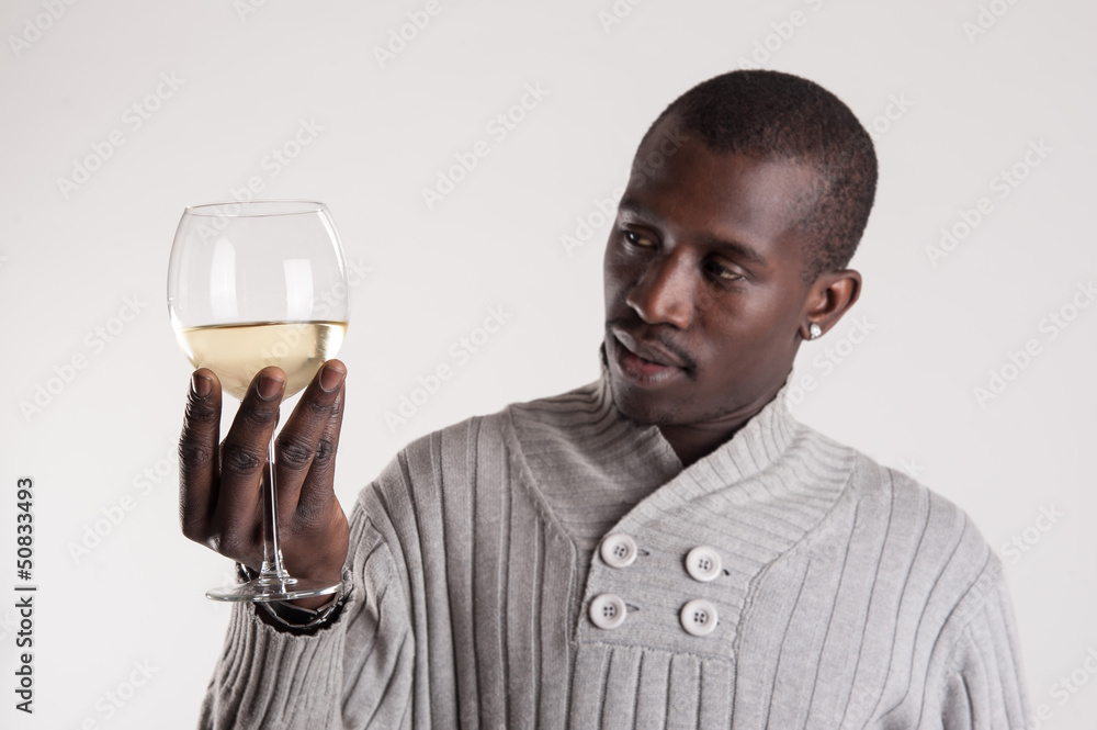 Confident young african man tasting glass of wine portrait. Confident young african man tasting glass of wine portrait.