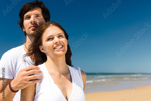 couple on the ocean beach at summer vacation