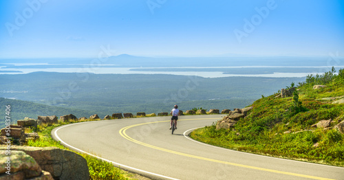 Female mountain bike cyclist riding downhill along Cadillac Moun