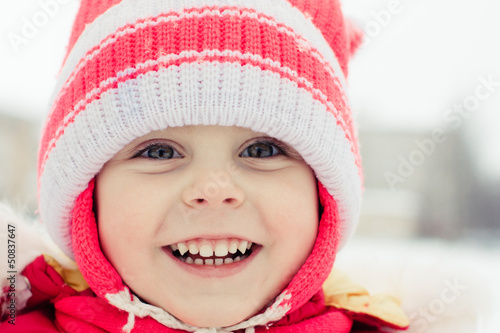 Beautiful happy kid in the red jacket