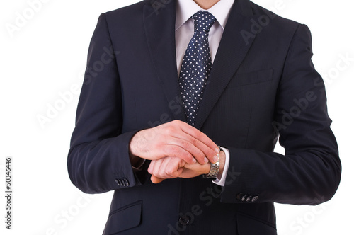 Businessman checking time on his wristwatch.