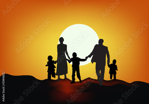 family silhouette at sunset