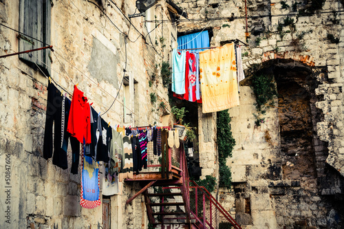 Scenery in old part of town showing laundry day © marinv