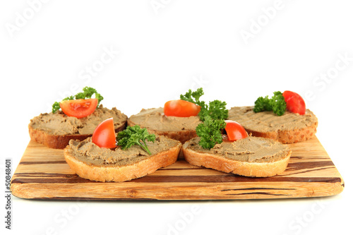 Fresh pate on bread on wooden board, isolated on white