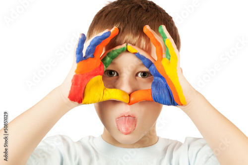 funny kid is hamming with coloured hand
