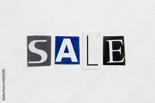 word sale cut from newspaper on white handmade paper