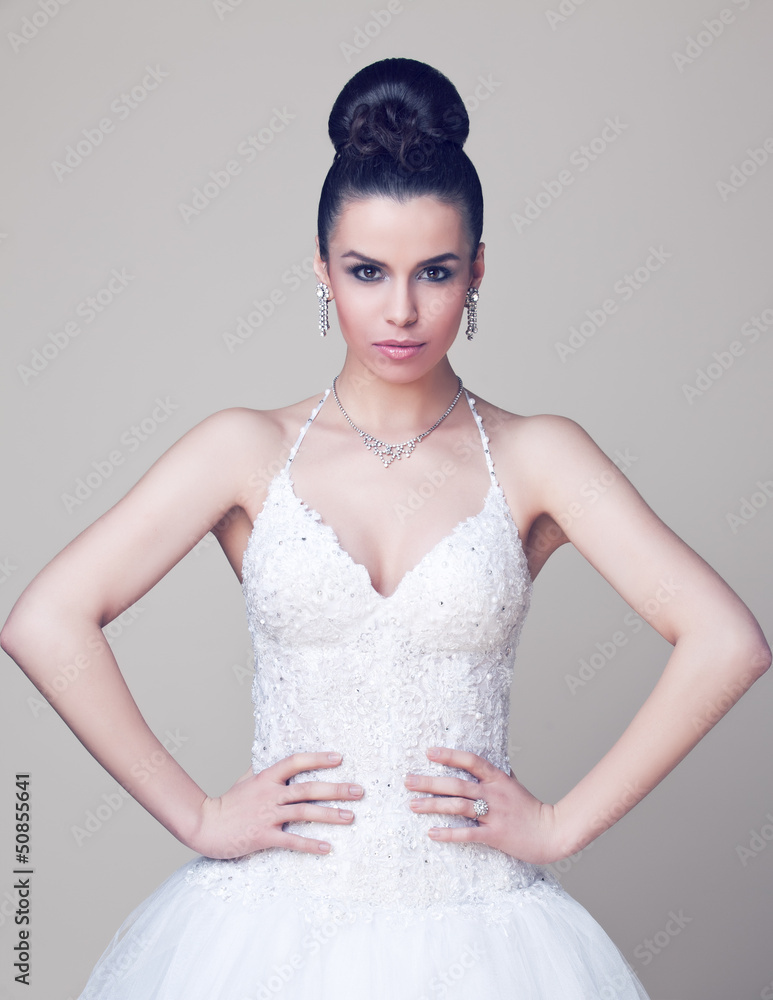 Young and beautiful bride standing in studio Young and beautiful bride standing in studio
