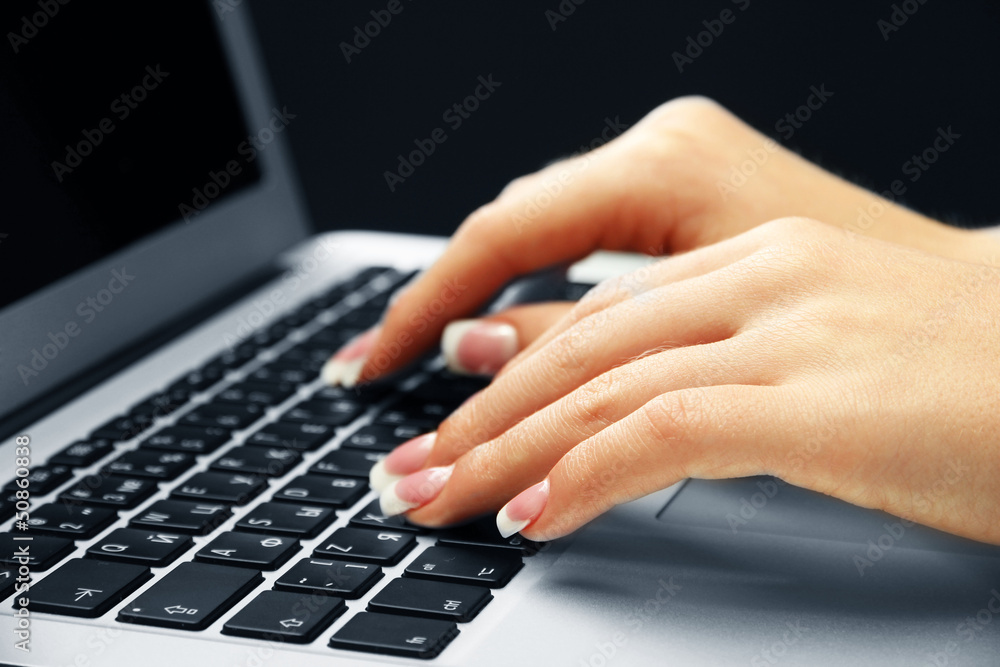 Female hands typing on laptot, close-up Female hands typing on laptot, close-up