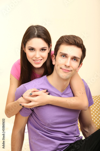 Young couple lying on carpet at home