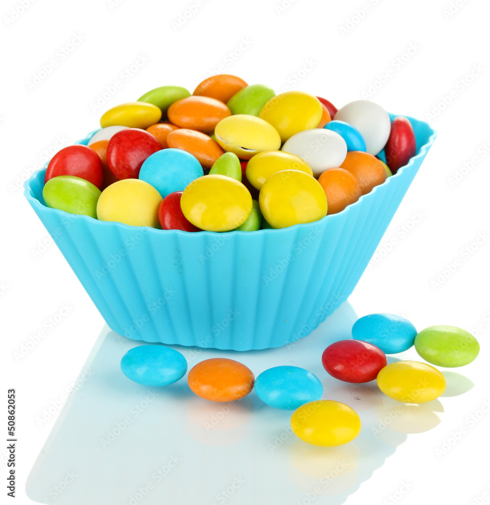 Colorful candies in cupcake case isolated on white Colorful candies in cupcake case isolated on white
