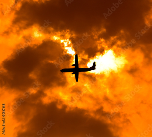 Aircraft on sunset background
