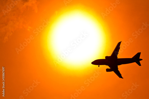 Aircraft on sunset background