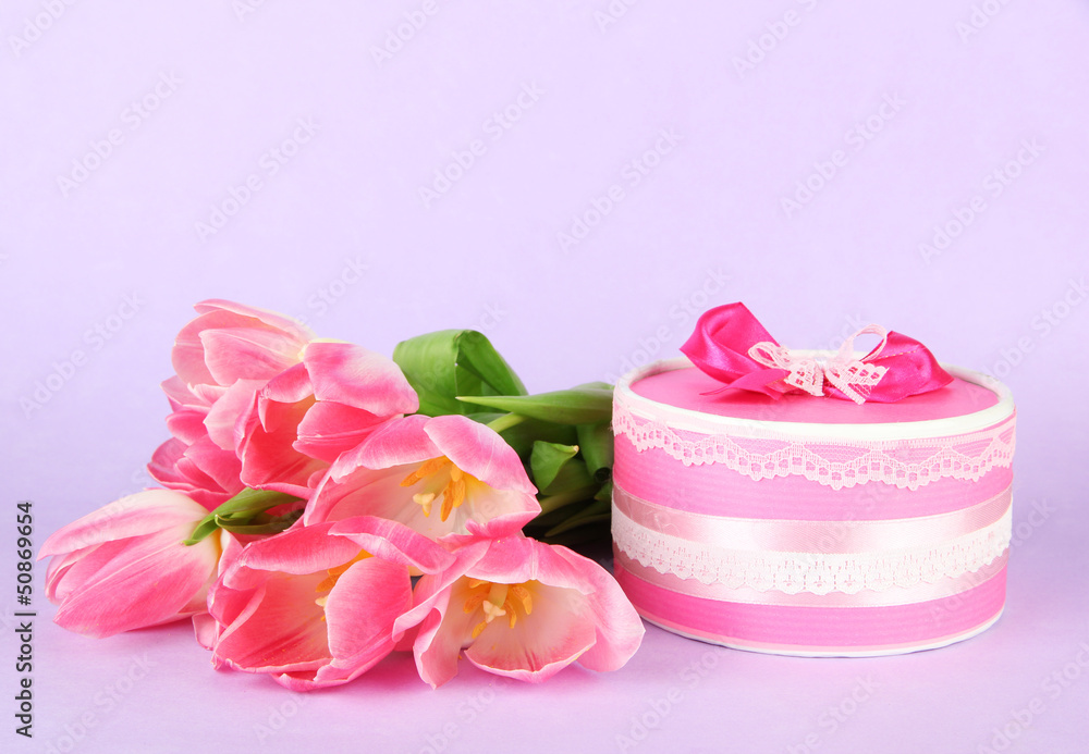 Pink tulips and gift box, on color background Pink tulips and gift box, on color background