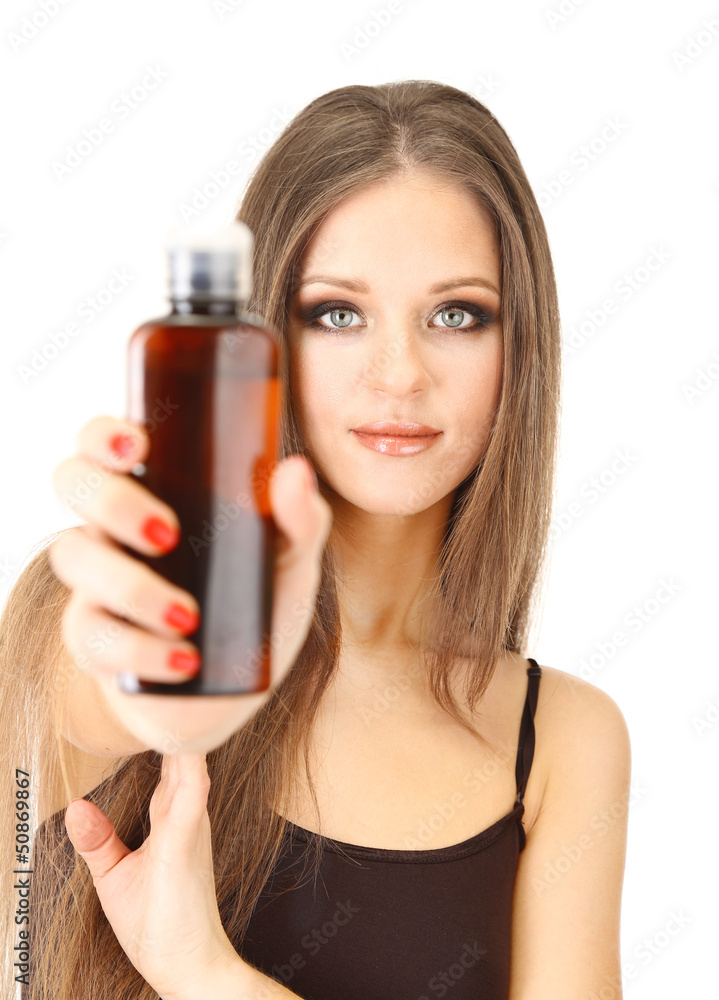 Woman with long hair holding bottle of shampoo, isolated Woman with long hair holding bottle of shampoo, isolated
