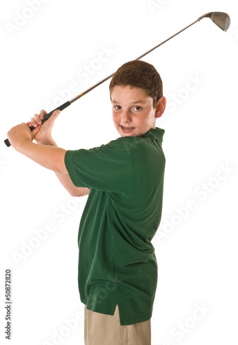 Young boy swining a golf club