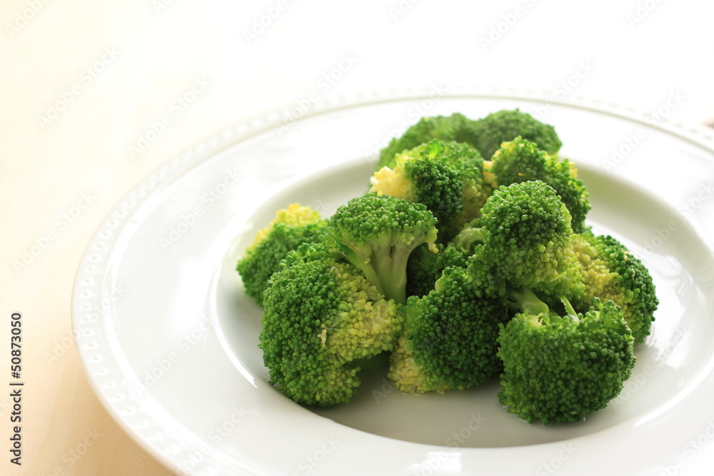 steamed broccoli on white dish with copy space steamed broccoli on white dish with copy space