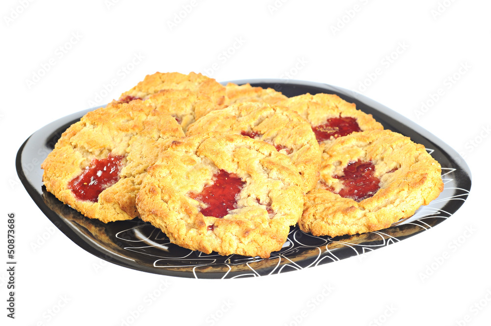 Delicious cookies with strawberry jam on a plate, white backgrou Delicious cookies with strawberry jam on a plate, white backgrou