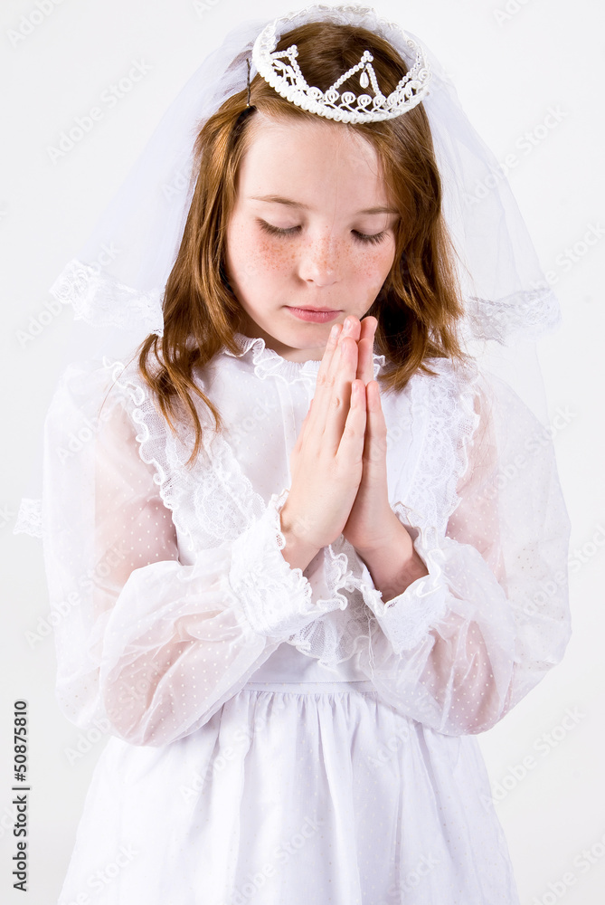 Young girl Praying in First Communion Attire Young girl Praying in First Communion Attire