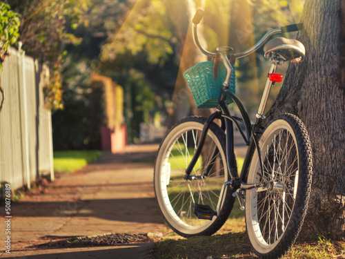 Retro bicycle on sunny street. Focus on rear wheel. #50876889