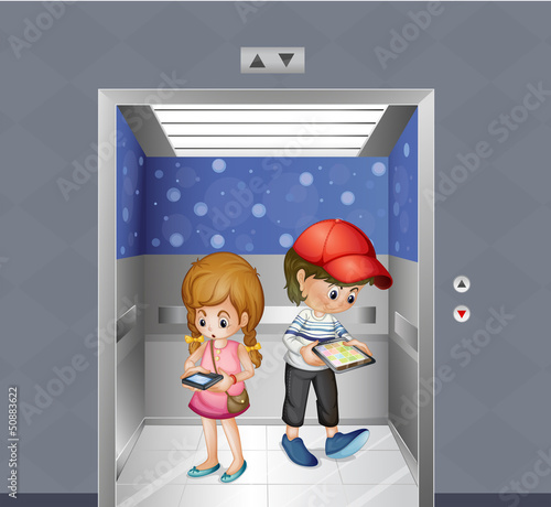Two kids holding gadgets inside the elevator