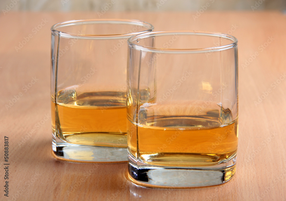 Whiskey glasses on wood