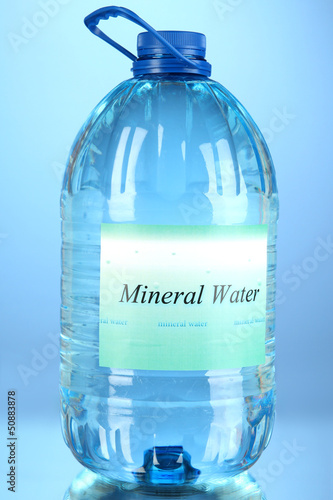 Big water bottle with label on blue background
