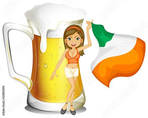 A girl holding a flag in front of a large glass of alcohol