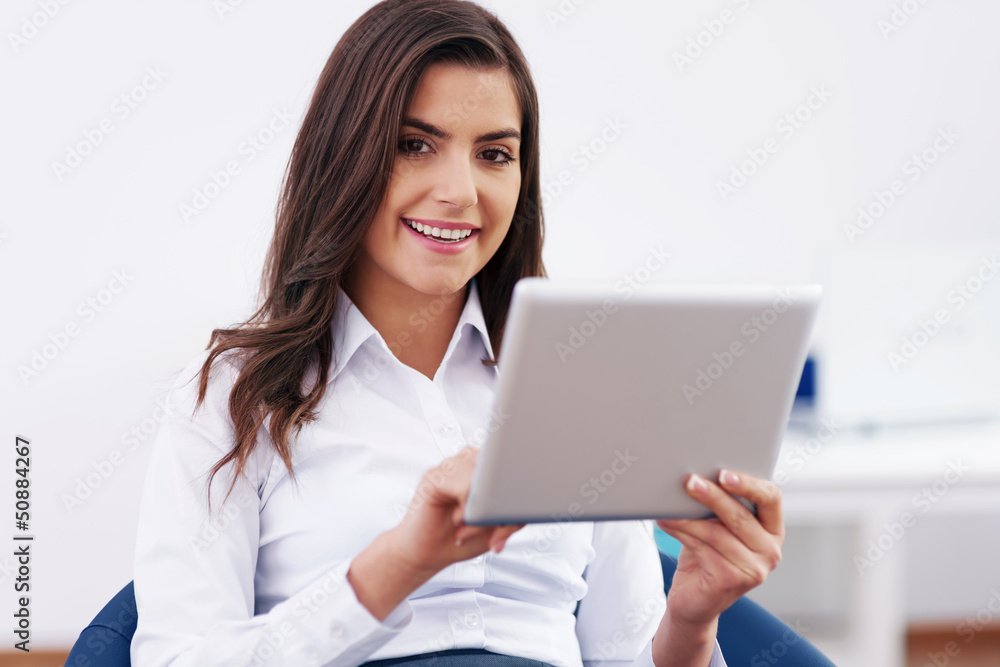 Smiling businesswoman using a digital tablet Smiling businesswoman using a digital tablet