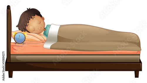 A boy sleeping with an alarm clock