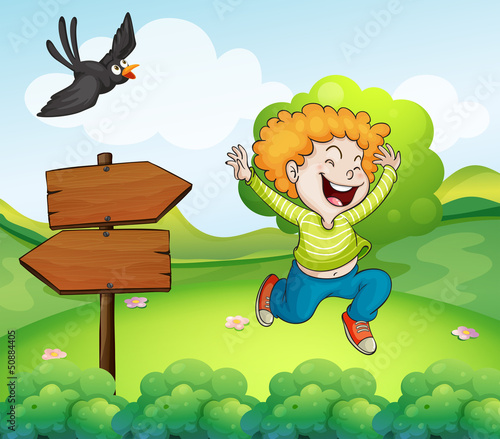 A black bird and a happy boy near the arrow signage