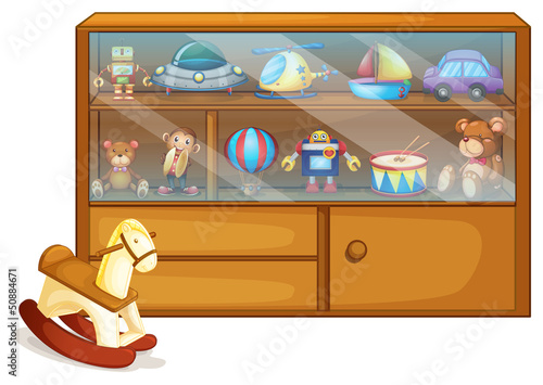 A horse toy beside a wooden cabinet