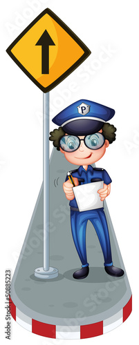 A policeman beside a yellow signage