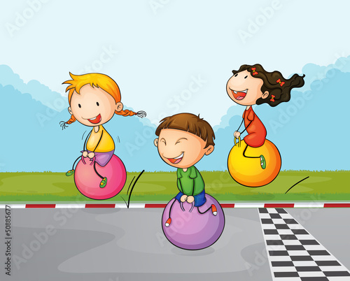 Three kids at the street with their bouncing balls