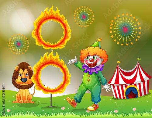 A ring of fire with a clown and a lion at the carnival