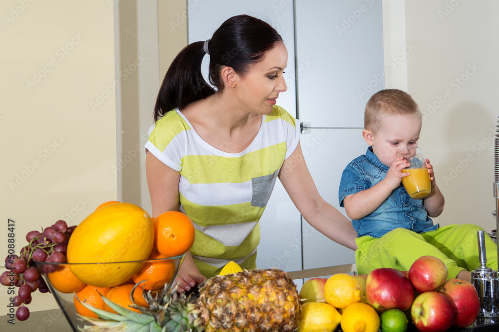 Mother and child making fresh orange juice - healthy life Mother and child making fresh orange juice - healthy life