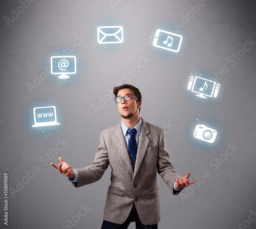 funny boy juggling with electronic devices icons © ra2 studio