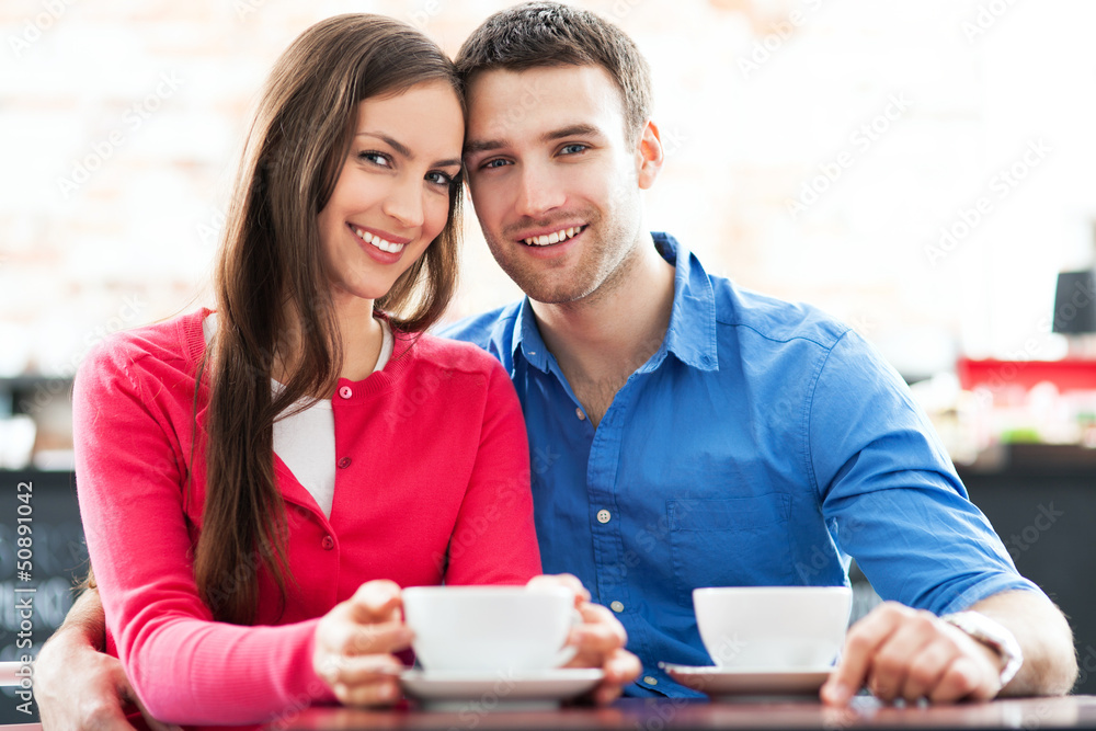 Couple sitting in cafe drinking coffee Couple sitting in cafe drinking coffee