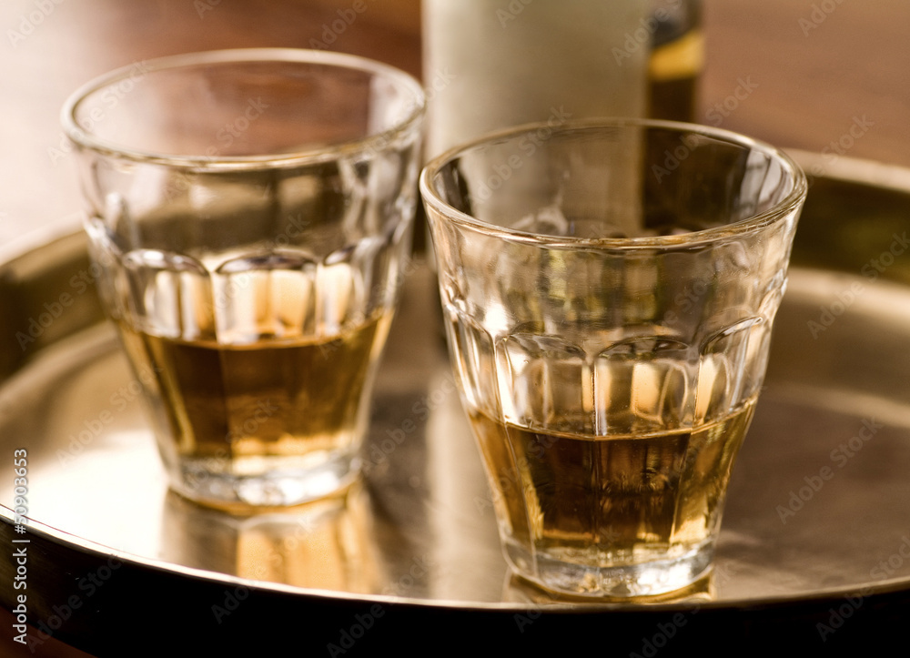 Two glasses of brandy on a brass tablet Two glasses of brandy on a brass tablet