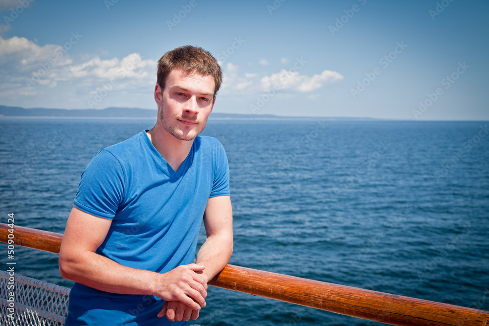 The young man on the deck against the sea