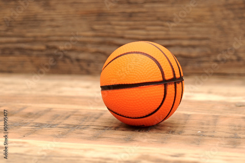 Toy basketball on wood background © vadim yerofeyev