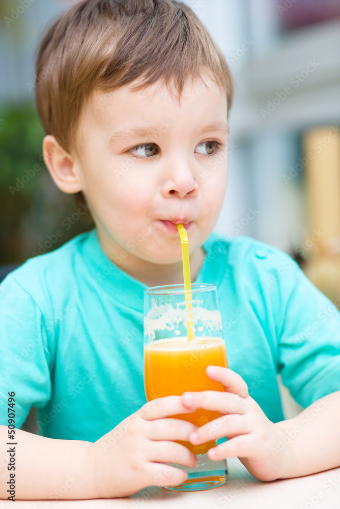 Little boy with glass of orange juice Little boy with glass of orange juice