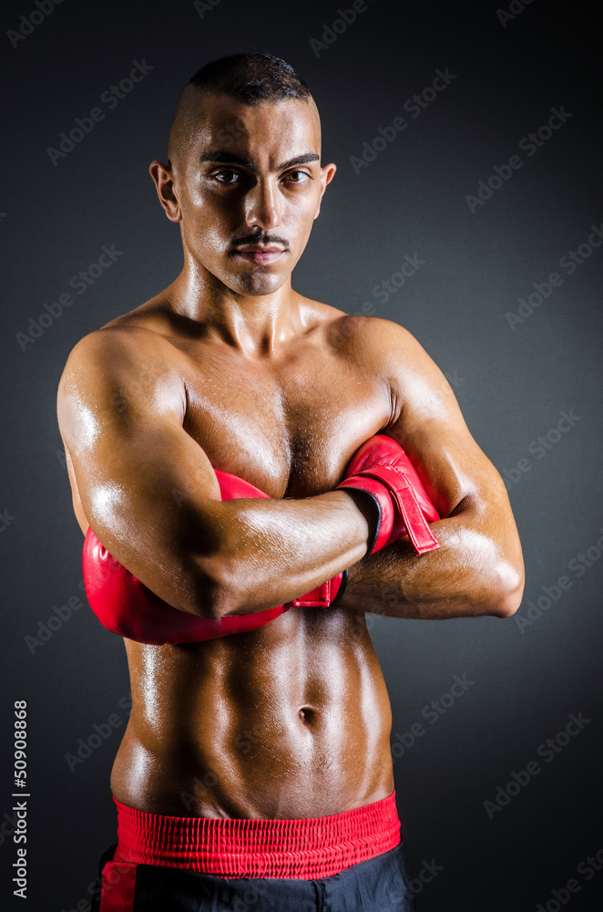 Boxer with red gloves in dark room Boxer with red gloves in dark room
