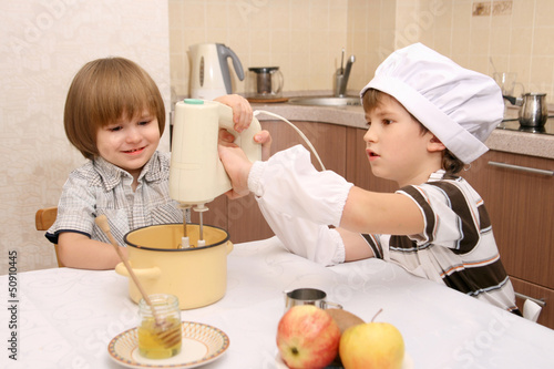 Two boys in kitchen with mixer photo