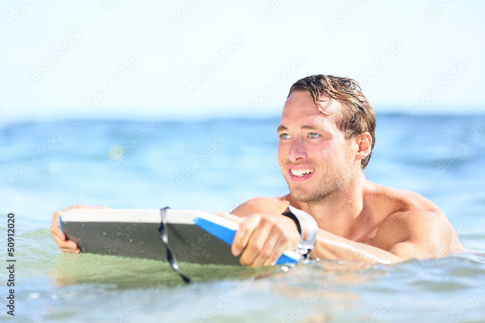 Beach fun - man bodyboarding on bodyboard