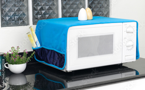 microwave oven with the cover blanket to protect dust or dirty