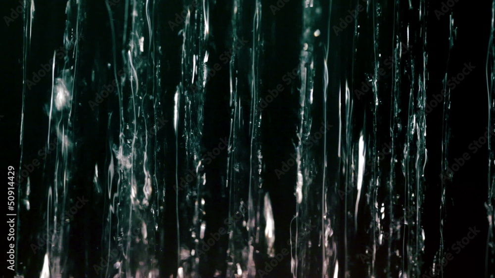 Water jets on black background. Macro shot. Water jets on black background. Macro shot.