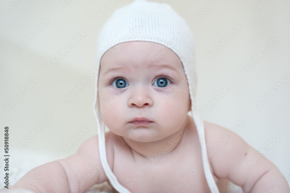 Beautiful little baby in a cap on white background Beautiful little baby in a cap on white background