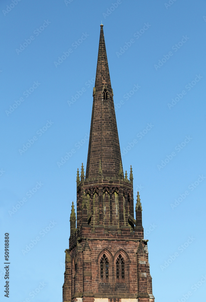 The Spire of a Country Church Against a Blue Sky.