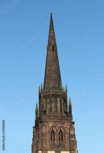 The Spire of a Country Church Against a Blue Sky.