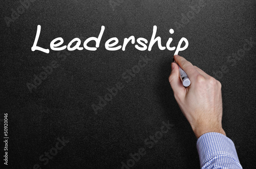 hand writing a leadership word